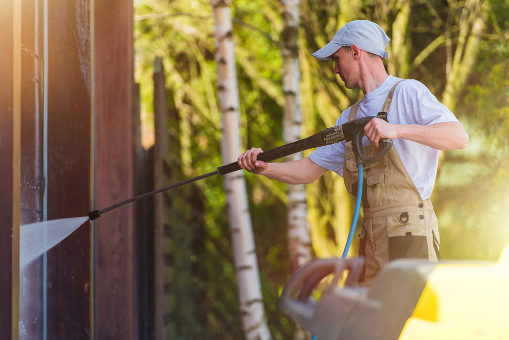 Man spraying deck